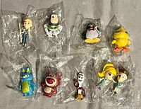All eight sealed Toy Story miniature PVC figure packs displayed