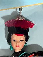 Close-up of Barbie’s head showing headdress, facial details and earrings