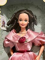 Close-up of Barbie doll inside original box, showing gown and accessories