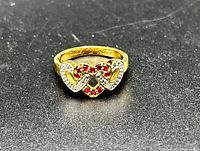 front view of gold ring with triple heart and gemstones