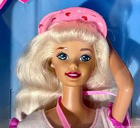 Close-up of doll face and upper body through packaging