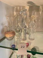 Shelf with five crystal vases including amber-band bud vase