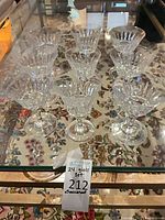 Group of Baccarat crystal coupes displayed on glass table