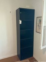 Front view of black laminate bookcase showing five shelves