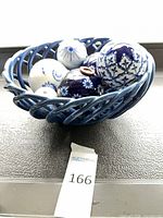 Blue ceramic lattice bowl with six blue and white decorative balls