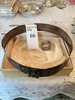 Waist belt and cuff in box showing scale and patina