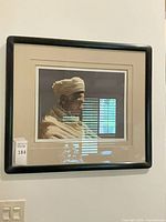 Framed portrait print in black frame with mat under glass