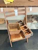 Wood folding chair and wicker basket displayed together
