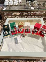 All seven silver bells displayed on individual boxes