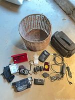 Overview of entire lot including basket, camcorder, accessories, cords and viewer
