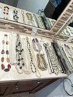 Multiple necklaces laid out on countertop