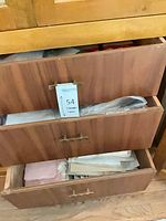 Two drawers containing stacked white and pink linens