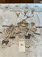 Group shot of candelabra, six goblets and plaque