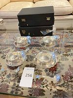 Overview of all visible pieces: four gravy boats on underplates, two ladles, two black cases