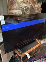 Front view of Toshiba 50" TV displaying blue "No Video" bar, remote visible on stand