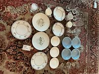 All dinnerware, bowls, glasses and mugs laid out
