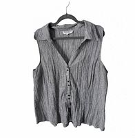 Front view of grey pinstripe sleeveless blouse on hanger