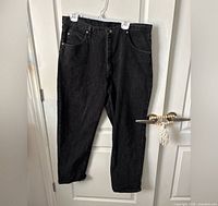 Full view of black Wrangler jeans hanging