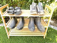 Rack with four pairs of shoes on top and lower shelf, showing overall lot contents
