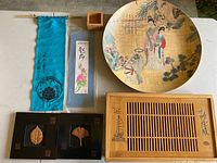 All items arranged: bamboo plate, tea tray, framed leaves, banner, watercolor, wood box