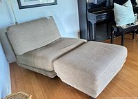 Chair with ottoman angled view showing upholstery and feet