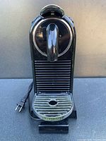 Front view of black Nespresso CitiZ espresso machine with cord