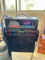 Front view showing dual cassette decks, speaker, controls and handle