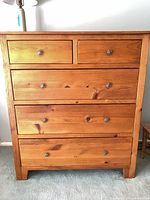 Front view showing all five drawers and knobs