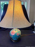Full view of lamp with shade illuminated