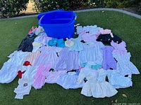 All garments spread out on artificial turf with blue plastic bin