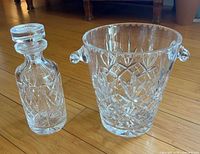 Ice bucket and decanter shown together displaying size, pattern, and clarity