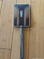 Back of rectangular Art Deco hand mirror showing geometric design and chrome frame