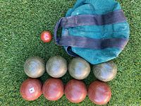 Complete bocce set on grass: bag, pallino, eight balls