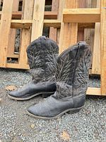 left side view of both boots showing decorative stitching and wear