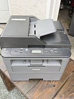 Front angled view of Brother DCP-L2550DW showing exterior, ADF and control panel