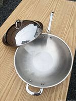 Interior view of stainless steel wok with lid set aside