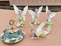 Group shot of all five fairy figurines on surface