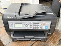 Front angle of Epson WF-2750 showing overall condition and lid damage