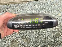 Front view showing GE logo, LED time display, AM/FM scale