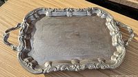Full view of rectangular silver-plate tray showing ornate rim and handles