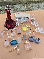 Group shot of all items: perfume bottles, mannequin, candle holders, vases, amethyst