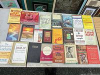Tabletop view of entire lot showing range of book titles and conditions