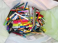 Top view of tote showing large assortment of colored pencils, markers, pens, highlighters