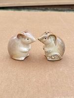 Front view of both glazed ceramic mouse shakers