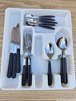 flatware arranged in plastic tray, top view