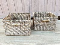 Front view of both seagrass baskets showing weave and wood handles