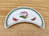 Front view showing floral and butterfly decoration and green leaf border