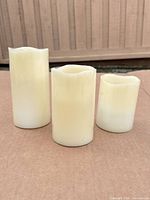 Front view of the three ivory flameless pillar candles showing overall appearance and heights