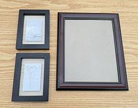 All three frames on tabletop, showing relative sizes and finishes
