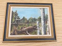 Front view of signed oil landscape in vintage wood frame